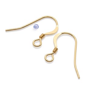 May include: Two gold-coloured earring hooks with a small, light blue bead. The hooks have a curved design with a looped end and a coiled wire detail. Jewellery making supplies.