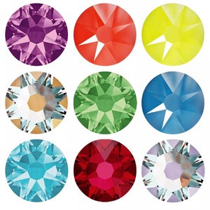 May include: Nine colorful, faceted gemstones in a variety of colors, including purple, red, yellow, clear, green, blue, and turquoise. Each gem is round with a starburst pattern.