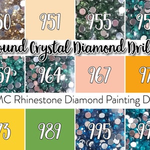 May include: Close-up of eight different colors of round crystal diamond drills for diamond painting. The colors are gold, light peach, green, teal, light green, pink, orange, yellow, dark green, blue, and turquoise. The numbers 950, 951, 955, 958, 959, 964, 967, 972, 973, 989, 995, and 996 are printed below each color.