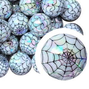 Peut inclure: Un groupe de perles rondes et brillantes de couleur blanche et noire avec un motif de toile d'araignée.