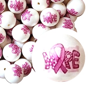 May include: White round beads with a pink ribbon and the word "HOPE" printed on them. The beads are scattered, with a close-up view of one bead showing the details of the design.