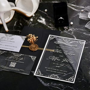 May include: A clear acrylic wedding invitation with black and white accents. The invitation features the names "Alen Wilson" and "Alfan Pless" with the date "10.07.2023" and the time "2PM". The invitation also includes the address "623 Anywhere St, Any City" and the RSVP deadline "RSVP before August 30".