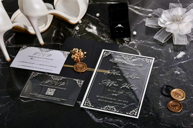 May include: A clear acrylic wedding invitation with black and white accents. The invitation features the names "Alen Wilson" and "Alfan Pless" with the date "10.07.2023" and the time "2PM". The invitation also includes the address "623 Anywhere St, Any City" and the RSVP deadline "RSVP before August 30".