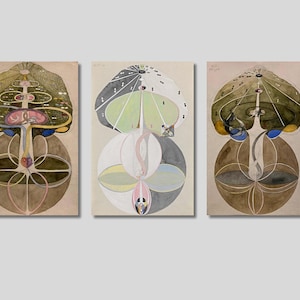 May include: Three abstract paintings in a row, each depicting a stylized tree with a circular base and a central stem. The top of each tree is a circular shape with a complex pattern of concentric circles and lines. The colors are muted and earthy, with shades of brown, green, blue, and yellow.