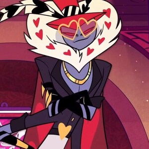 May include: A cartoon character with a white, heart-shaped head and red heart accents. The character wears heart-shaped sunglasses, a red top hat, and a black suit with a gold heart-shaped detail. A gold necklace is also visible.