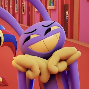 May include: A cartoon character with a purple head, long ears, and a wide yellow grin. The character has yellow hands and is set against a red and pink background. The character appears to be smiling.