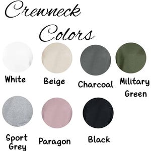 May include: Image showcasing a selection of crewneck colors. The colors include white, beige, charcoal, military green, sport grey, paragon, and black. The text "Crewneck Colors" is written in a cursive font at the top of the image.