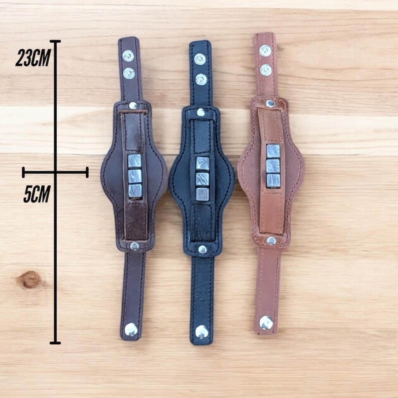 May include: Three leather bracelets with metal accents. The bracelets are 23 cm long and 5 cm wide. The bracelets are brown, black, and tan.
