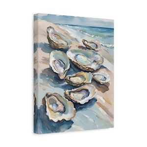 May include: A canvas print featuring a watercolor painting of multiple open oyster shells scattered across a sandy beach. The scene depicts the shells in shades of white, tan, and blue, resting near the edge of a calm, light blue ocean shoreline.