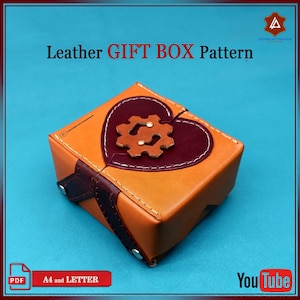 May include: A brown leather gift box with a heart-shaped lid. The lid is decorated with a brown leather gear design and a burgundy leather heart. The box is on a blue background. The text "Leather GIFT BOX Pattern" is at the top of the image. The text "A4 and LETTER" is at the bottom of the image.