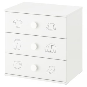 May include: A white three-drawer dresser with round white knobs. Each drawer features a black line drawing of clothing items: a t-shirt, a long-sleeved shirt, pants, a jacket, a diaper, and socks. The dresser is a cube shape.