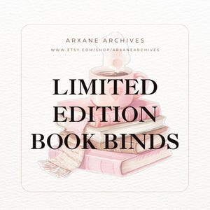 May include: A stack of books with a pink mug of coffee on top, and a scarf draped over the books. The text "LIMITED EDITION BOOK BINDS" is displayed in large, bold letters. The shop name and website are also visible.