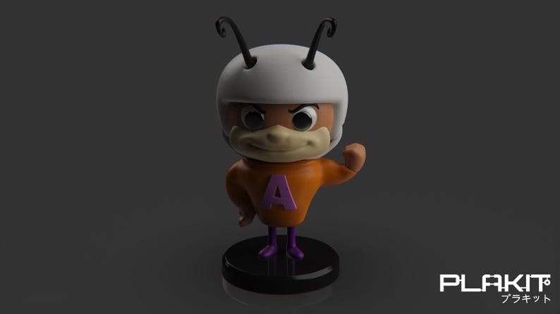 Puede incluir: Una figurita de personaje de dibujos animados con un casco blanco, una camisa naranja con una "A" morada en el frente y botas moradas. El personaje tiene una apariencia de insecto con antenas y una cara grande y expresiva.