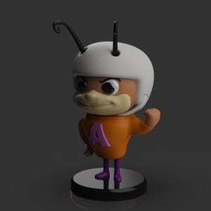 Puede incluir: Una peque&ntilde;a figura naranja y morada de un personaje de dibujos animados que lleva un casco blanco con una antena negra. El personaje tiene una nariz grande y marr&oacute;n y levanta el brazo derecho en un pu&ntilde;o.