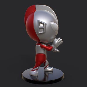 May include: A stylized figurine of a superhero in a dynamic pose. The figure features a red and silver color scheme, with a rounded head and detailed facial features. It stands on a black circular base, with the "PlaKit" logo in the bottom right corner.