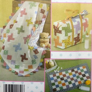 May include: Simplicity Quilt in a Day pattern featuring pinwheel quilts. The image shows a quilt, diaper bag, and baby changing pad. The quilt measures 37" x 42". The diaper bag and changing pad are also shown.