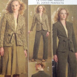 May include: A sewing pattern envelope titled THE PERFECT SUIT featuring illustrations of a jacket with a tie-front closure, a skirt, and trousers. The jacket is shown in both a patterned fabric and a solid dark color, paired with a light top.