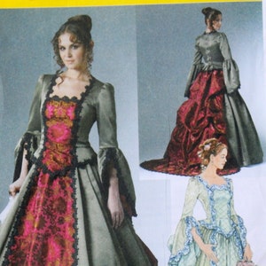 May include: A sewing pattern for a long, flowing gown with a fitted bodice and a full skirt. The gown features a lace trim and a contrasting fabric panel down the front. The pattern includes instructions for making two different styles of the gown.