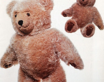 May include: Two brown teddy bears are featured in this image. One is a large, standing bear with a smiling face, and the other is a smaller bear in a sitting position. Both bears have dark brown paws and noses. The bears are made of a soft, plush material.