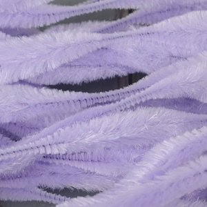 May include: A bundle of soft, lavender-coloured pipe cleaners. The pipe cleaners are twisted and curled, creating a textured and fluffy appearance.