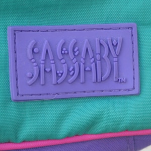 May include: Purple label with the text "SASSABY" in a stylized font with a trademark symbol.