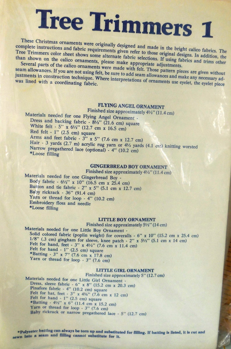 May include: A vintage instruction sheet titled "Tree Trimmers 1" with detailed instructions for making Christmas ornaments. The sheet lists materials like felt, fabric, and yarn, with measurements in inches and centimeters. Includes instructions for angel, gingerbread boy, and little boy and girl ornaments.