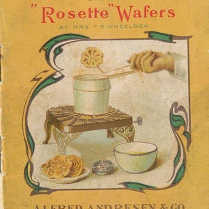 May include: Vintage cookbook cover titled "How to Make Dainty Rosette Wafers" by Mrs. T.B. Wheelock. The cover features an illustration of rosette wafers being made, with a pot on a small stove, a bowl, and the text "Alfred Andresen & Co."