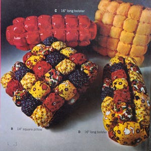 May include: An assortment of decorative pillows and bolsters in various colors and patterns. The image includes a 14-inch square pillow and a 16-inch long bolster, along with other similar items. The pillows feature a quilted design.