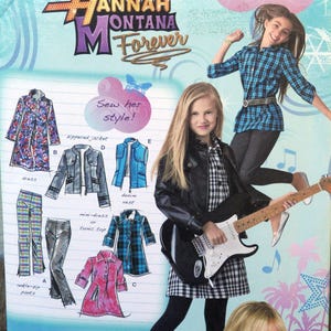 May include: An illustration from a "Hannah Montana Forever" magazine featuring fashion sketches. The image includes drawings of various clothing items like a dress, jacket, pants, and a denim vest. Two girls are also featured, one playing a guitar.