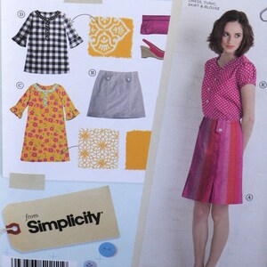 May include: A sewing pattern for a dress, tunic, skirt and blouse. The pattern includes a black and white gingham dress, a yellow floral dress, a grey skirt and a pink blouse with white polka dots. The pattern is from Simplicity.