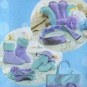 May include: A set of lavender and teal bath and spa items, including a headband, slippers, gloves, and a neck wrap. The items are made of soft, plush fabric.