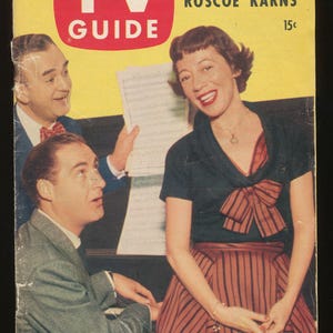 May include: A vintage TV Guide magazine cover from July 31 to August 6, featuring the text How TV Rescued Roscoe Karns and Max Liebman Reveals New Plans for Caesar and Coca. The cover displays three people, including a woman in a dark top and striped skirt.