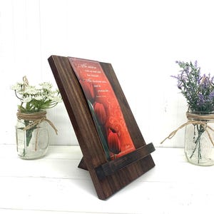 May include: A dark brown wooden stand with a small shelf for holding a card or small book. The card in the stand has a red tulip design and a quote that reads "Her children rise up and call her blessed; her husband also, and he praises her." Proverbs 31:28