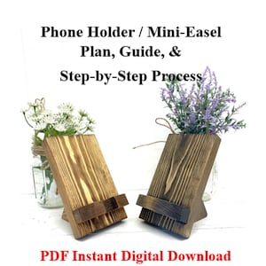 May include: Two wooden phone holders with a mini-easel design. The holders are stained in a warm brown color and feature a support ledge. The image includes text that reads "Phone Holder / Mini-Easel Plan, Guide, & Step-by-Step Process" and "PDF Instant Digital Download."
