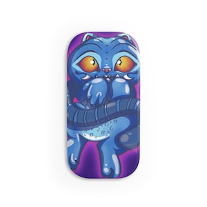 May include: A blue cartoon cat illustration with large orange eyes and a striped tail. The cat is on a purple background. The design is on a rectangular object with rounded edges.