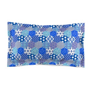 May include: A blue and white patterned pillow with a geometric design. The pillow is made of soft, comfortable fabric and is perfect for adding a touch of style to any room.