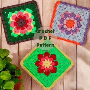 May include: Three crocheted squares with colourful flower designs. The squares are green, blue, and red with yellow, pink, and orange accents. The squares are on a wooden surface. Crochet PDF Pattern.