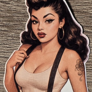 May include: A sticker featuring a pin-up girl illustration. The woman is wearing a white tank top, denim shorts, and suspenders. She has dark hair, hoop earrings, and a tattoo on her arm. The artwork has a vintage aesthetic.