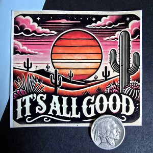 May include: A sticker with a sunset scene featuring a large orange sun, pink clouds, and cacti. The text "IT'S ALL GOOD" is written in white letters on a black background.