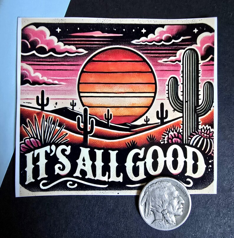 May include: A sticker with a sunset scene featuring a large orange sun, pink clouds, and cacti. The text "IT'S ALL GOOD" is written in white letters on a black background.