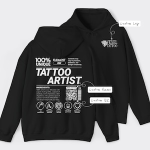 May include: Black hoodie featuring the text "TATTOO ARTIST" in white, along with the words "100% UNIQUE" and "ELEMENT INK." The design includes a QR code and the Vexel Tattoo logo. The hoodie has a drawstring hood.