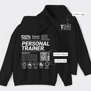 May include: Black hoodie with white text that reads "PERSONAL TRAINER." The hoodie features a logo on the upper right and a QR code. The text includes "100% STRENGTH" and "ELEMENT MOTIVATION."