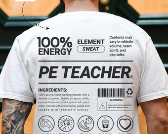 May include: White t-shirt with black text. The shirt reads "100% ENERGY" and "PE TEACHER" with additional text about ingredients and warnings. Features icons for whistle, motivation, training, caffeine, and love.