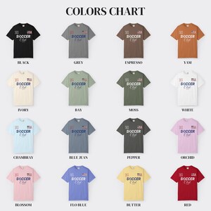 May include: A color chart displaying sixteen short-sleeve t-shirts in various colors including black, grey, espresso, yam, ivory, bay, moss, white, chambray, blue jean, pepper, orchid, blossom, flo blue, butter, and red, all featuring the text Soccer Club.