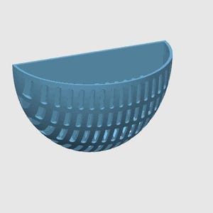 May include: A semi-circular bowl in a matte blue finish, featuring a textured exterior with a repeating pattern of vertical indentations. The bowl has a flat top edge and a curved bottom, presenting a simple, functional design for various uses.