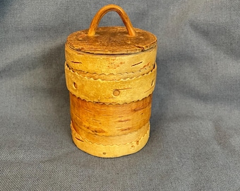 Vintage birch bark storage container with a lid.