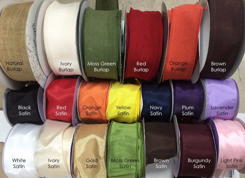 May include: A variety of ribbon spools in different colors and textures, including burlap and satin. The colors include natural, ivory, moss green, red, orange, brown, black, yellow, navy, plum, lavender, white, gold, burgundy, and light pink.