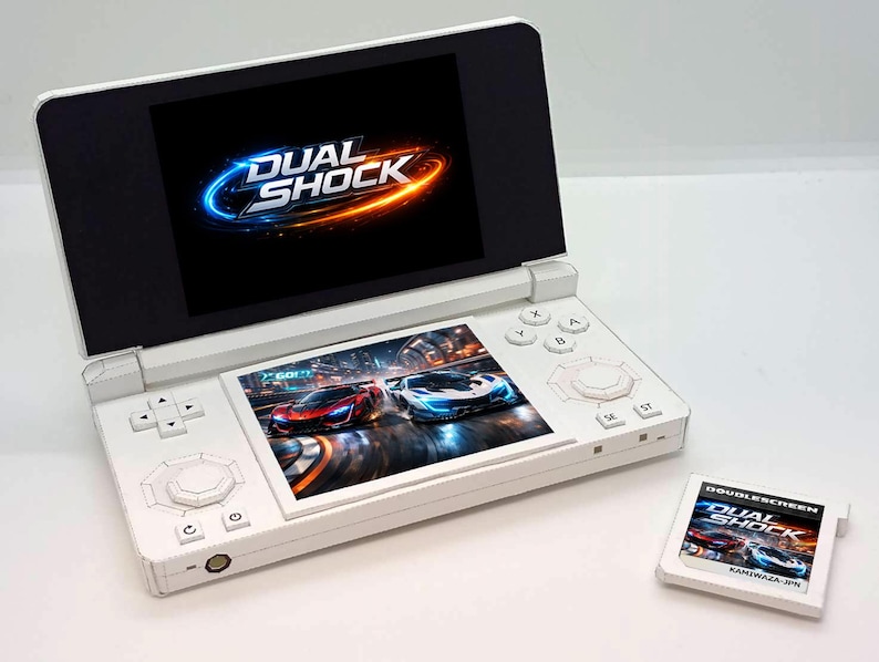 May include: A white handheld gaming console with two screens, displaying the game "Dual Shock." The bottom screen shows race cars. A game cartridge with the same title is next to the console.