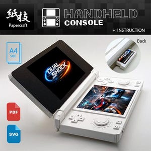 May include: A white papercraft handheld console with a black top screen displaying "DUAL SHOCK" in blue and orange. The console has buttons and a game screen. Text includes "HANDHELD CONSOLE" and "+ INSTRUCTION".