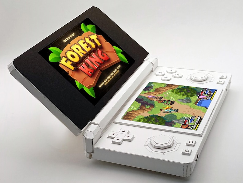 May include: A white handheld gaming console with a game screen displaying a colorful fantasy game. The top screen shows the text "FOREST KING" in a stylized font. The console's buttons and directional pad are white.